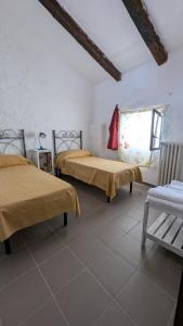 a room with two beds and a window in it at Masseria Mustazzo in Siponto +36 photos