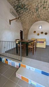 a dining room with a table and a couch at Masseria Mustazzo in Siponto