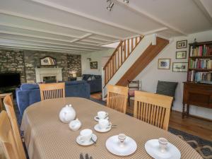 a dining room with a table and a living room at Tegfan in Newport