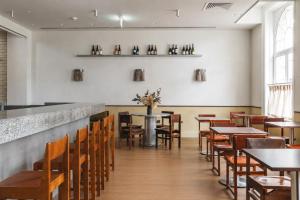 a dining room with tables and chairs and a counter at Arthouse Glasgow - Newly Refurbished in Glasgow