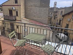 two chairs and a table on a balcony at B&B Sant'Anna in Lercara Friddi