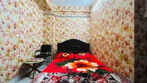a bedroom with a red bed with a flower on it at Hotel Paradise Residential in Dhaka