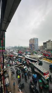 a city with a lot of traffic and buses at Hotel Paradise Residential in Dhaka +48 photos