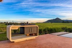 a barbecue on a patio with a view of a field at Viento Blanco in Independencia +19 photos