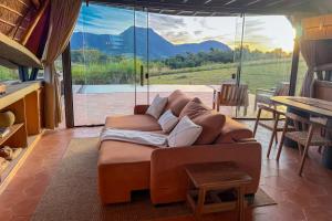 a living room with a couch and a large window at Viento Blanco in Independencia