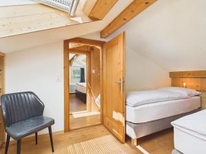 a bedroom with a bed and a chair in a room at Guardian Gate Lodge in Iseltwald