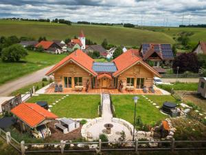 an aerial view of a house with a train in the yard at Chalets Waldeck - Urlaub im Fränkischen Seenland und Altmühltal in Raitenbuch