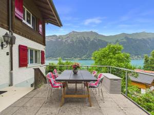 a table and chairs on a balcony with a view at Guardian Gate Lodge in Iseltwald