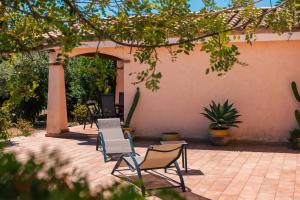 a group of chairs sitting on a patio at Residenze Camboni in Castiadas