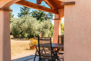a wooden table and chairs on a porch at Residenze Camboni in Castiadas