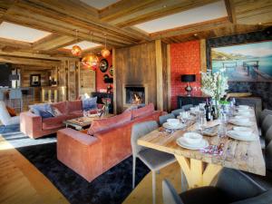 a living room with a table and a couch at Chalet Kalyssia - OVO Network in Saint-Jorioz +27 photos