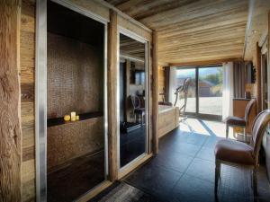 a room with a glass door with a desk and chairs at Chalet Kalyssia - OVO Network in Saint-Jorioz