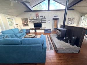 a living room with blue couches and a fireplace at BEAUTIFUL Rustic Modern Remodel IDEAL Location!! in Pagosa Springs