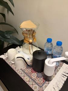 a blender on a table with cups and water bottles at ترف in Medina +9 photos