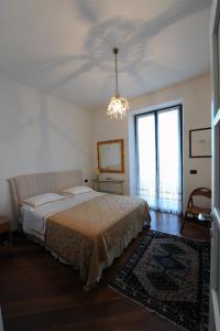 a bedroom with a bed and a chandelier at La Torretta Rosa in La Spezia