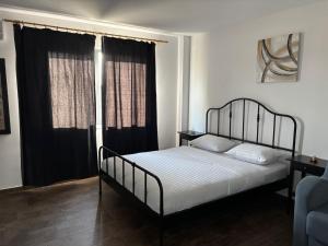 a bedroom with a bed and a large window at SeaEsta Studio in Agigea