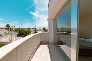 a balcony with a view of the city at Hotel Aurora in Porto Cesareo +56 photos