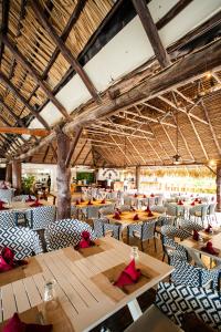 a dining room with wooden tables and chairs at Playa Blanca Beach Resort - All Inclusive in Playa Blanca