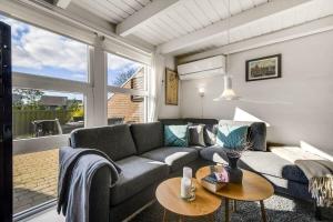a living room with a couch and a table at C11699-Hemmet-Vester-Faelled-70-A5 in Hemmet