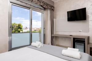 a bedroom with a bed with a fireplace and a tv at Hotel Aurora in Porto Cesareo
