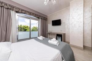 a bedroom with a large bed with a fireplace and a tv at Hotel Aurora in Porto Cesareo