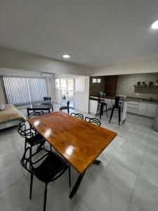 a large living room with a wooden table and chairs at uriburu45 in Malargüe