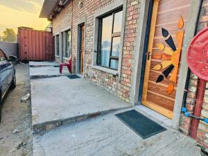 a brick building with a door and a window at Acasa do Delco Accommodatiion in Welkom