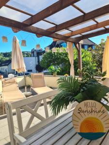 a patio with a table and chairs and an umbrella at Ferienwohnung Sonne in Schliengen