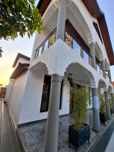 a house with pillars in front of it at Kigali Alba Home in Kigali +22 photos
