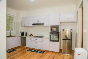 a kitchen with white cabinets and stainless steel appliances at Coastal Haven 3 Bed Nyali in Mombasa