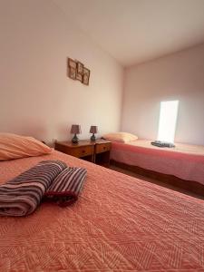 a bedroom with two beds and a window at Apartmani Maria in Preko