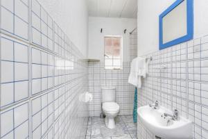 a white bathroom with a toilet and a sink at Mandy place in Sandown