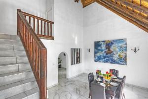 a dining room with a staircase and a table and chairs at Mandy place in Sandown +16 photos