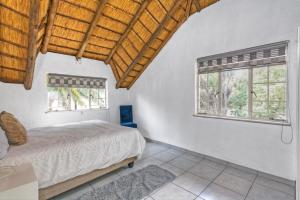 a bedroom with a bed and two windows at Mandy place in Sandown