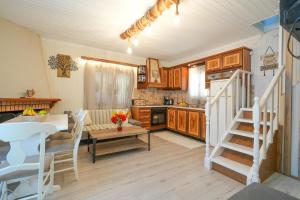 a kitchen and living room with a table and a staircase at Sofia-Irini in Kalamaki +34 photos