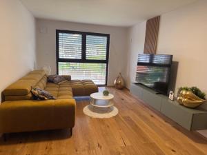 a living room with a couch and a table at Villa Vita - MELANI in Slovenj Gradec
