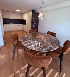a dining room with a marble table and chairs at Villa Vita - MELANI in Slovenj Gradec