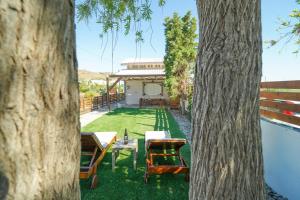 a view of a yard with a table and chairs at Sofia-Irini in Kalamaki