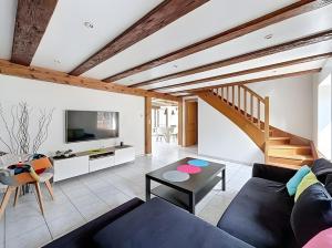 a living room with a couch and a table at Gite Loan proche Colmar in Ingersheim