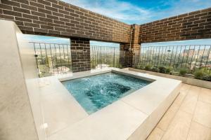 a swimming pool in the middle of a building at Apartamento Moderno z 10-Jacuzzi-Lavandería-AC-Gym-GuatemalaCity in Lo de Contreras