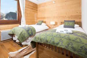 Giường trong phòng chung tại Le Paradis 24 apartment - Chamonix All Year
