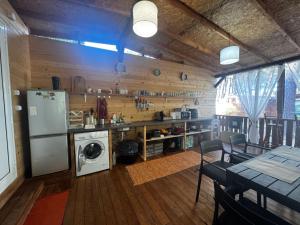 a kitchen with a refrigerator and a washer and dryer at karavana.ta in Chernomorets
