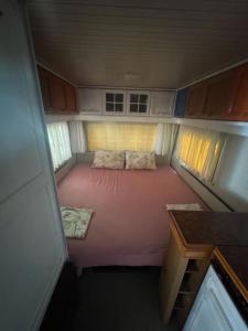 a small bed in the back of an rv at karavana.ta in Chernomorets
