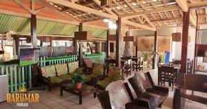 a living room with a couch and chairs and a table at Pousada Barumar in Lucena