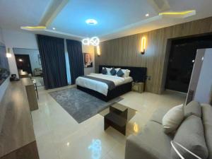 a large bedroom with a bed and a couch at IP Hotels And Towers in Chori