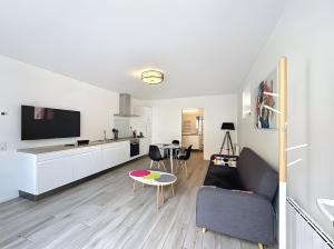 a living room with a couch and a table at Gite Leny proche Colmar in Ingersheim +4 photos