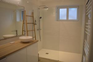 a bathroom with a sink and a glass shower at Gite Leny proche Colmar in Ingersheim