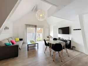 a living room with a table and a couch at Gite Donald proche Colmar in Ingersheim