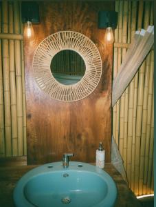a bathroom with a sink and a mirror at Glamping villeta campo heliconias in Villeta +13 photos