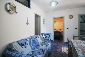 a living room with a couch and a table at Appartamento Buggerru Blue Nest in Buggerru